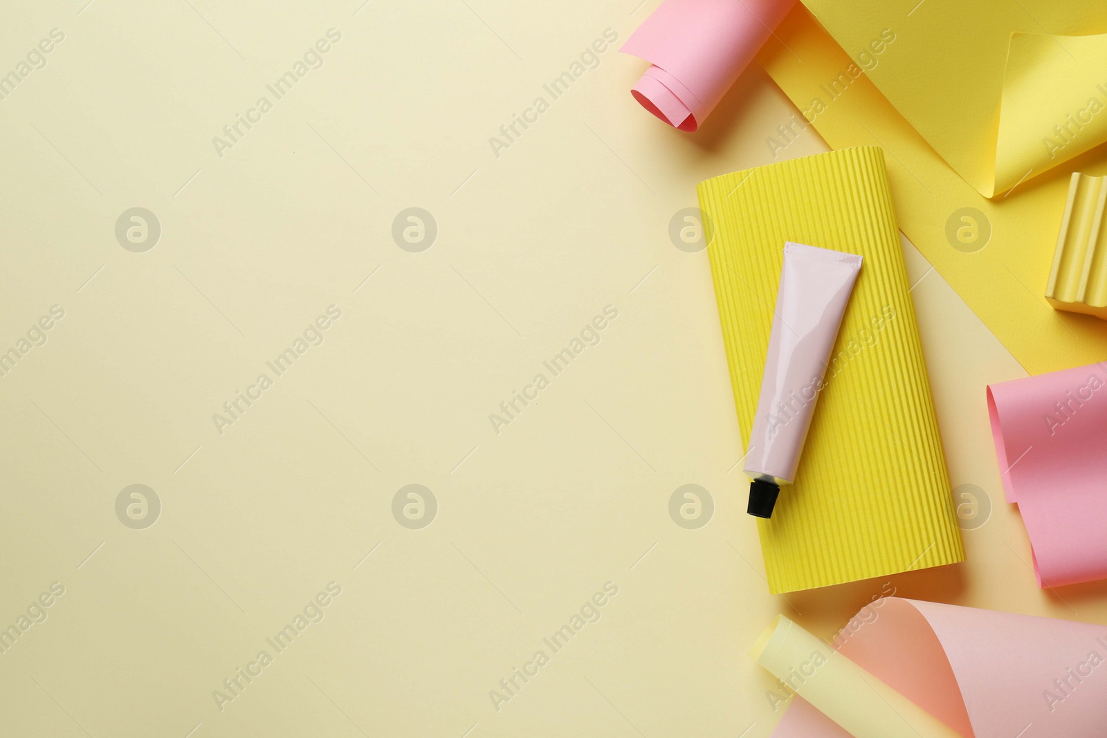 Photo of Flat lay composition with tube of cream on beige background, space for text