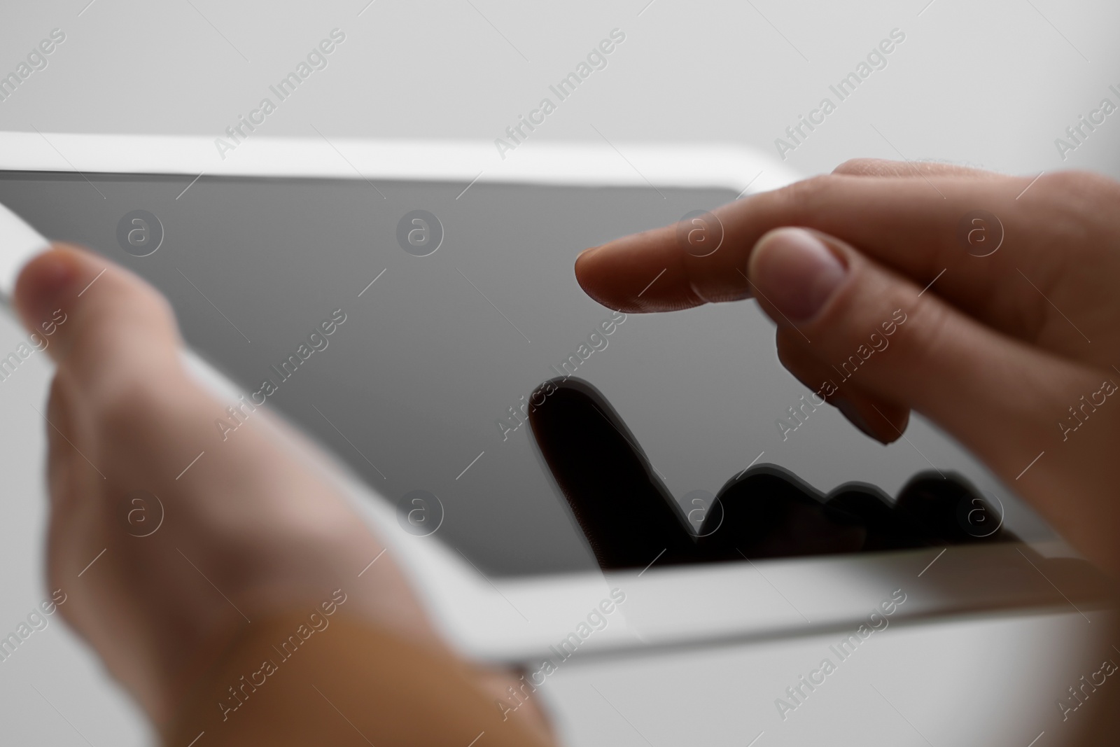 Photo of Closeup view of woman using modern tablet on light grey background