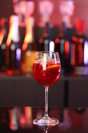 Photo of Glass of delicious refreshing sangria on counter in bar