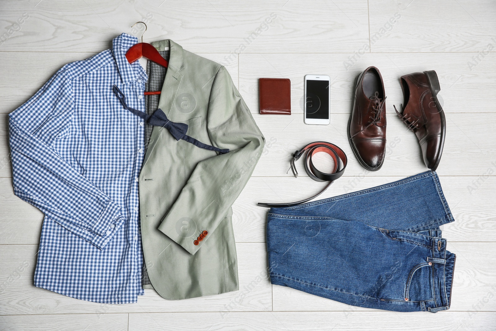 Photo of Male clothes, footwear and accessories on wooden background