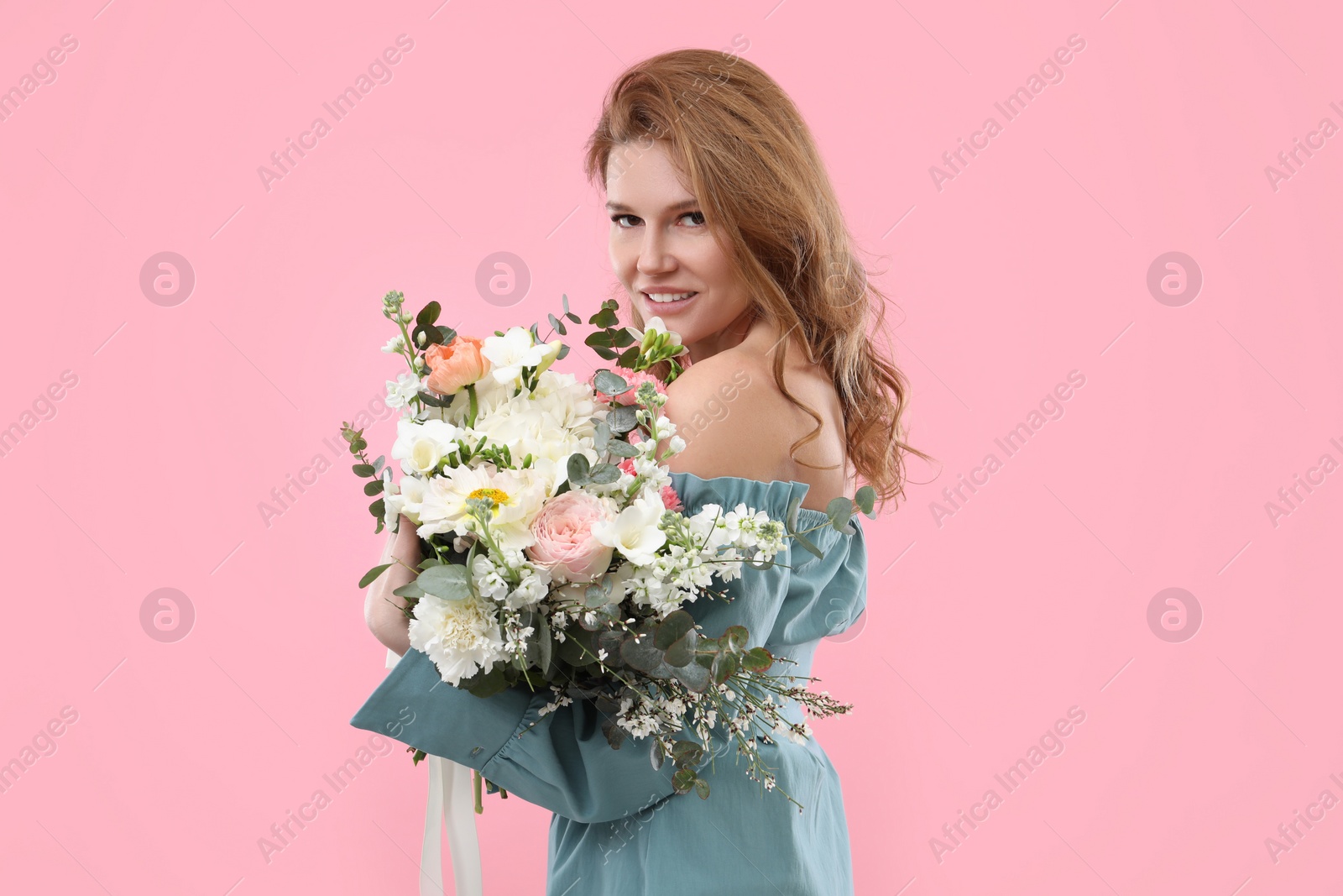 Photo of Beautiful woman with bouquet of flowers on pink background