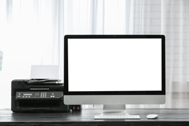 Computer on desk near window in home office. Comfortable workplace