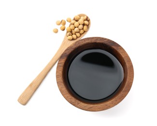 Photo of Tasty soy sauce in bowl, soybeans and spoon isolated on white, top view