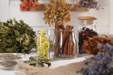 Photo of Many different dry herbs and flowers on white table