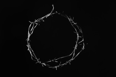 Photo of Shiny metal barbed wire on black background