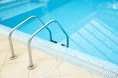 Ladder with grab bars in swimming pool