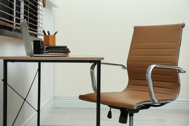 Stylish workplace interior with modern office chair