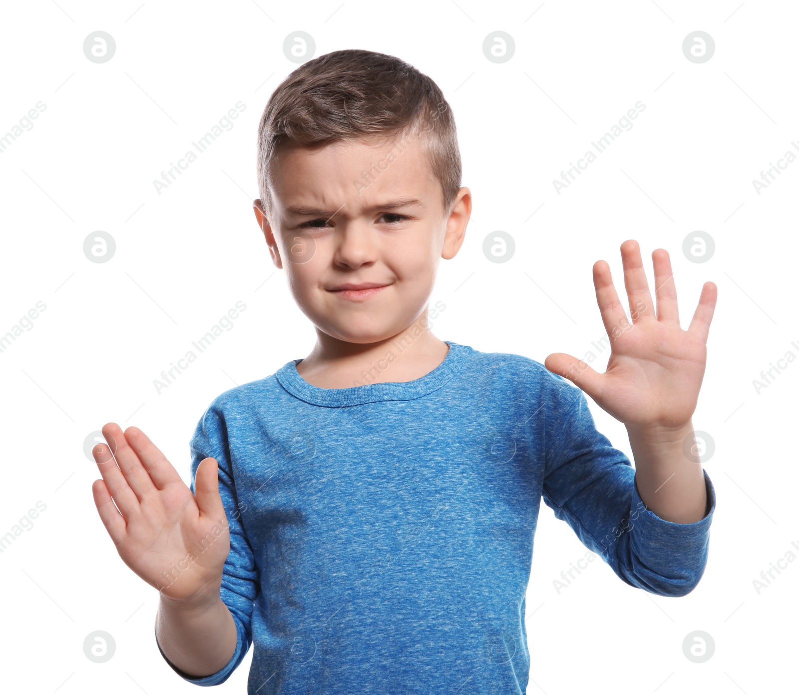 Photo of Little boy showing STOP gesture in sign language on white background