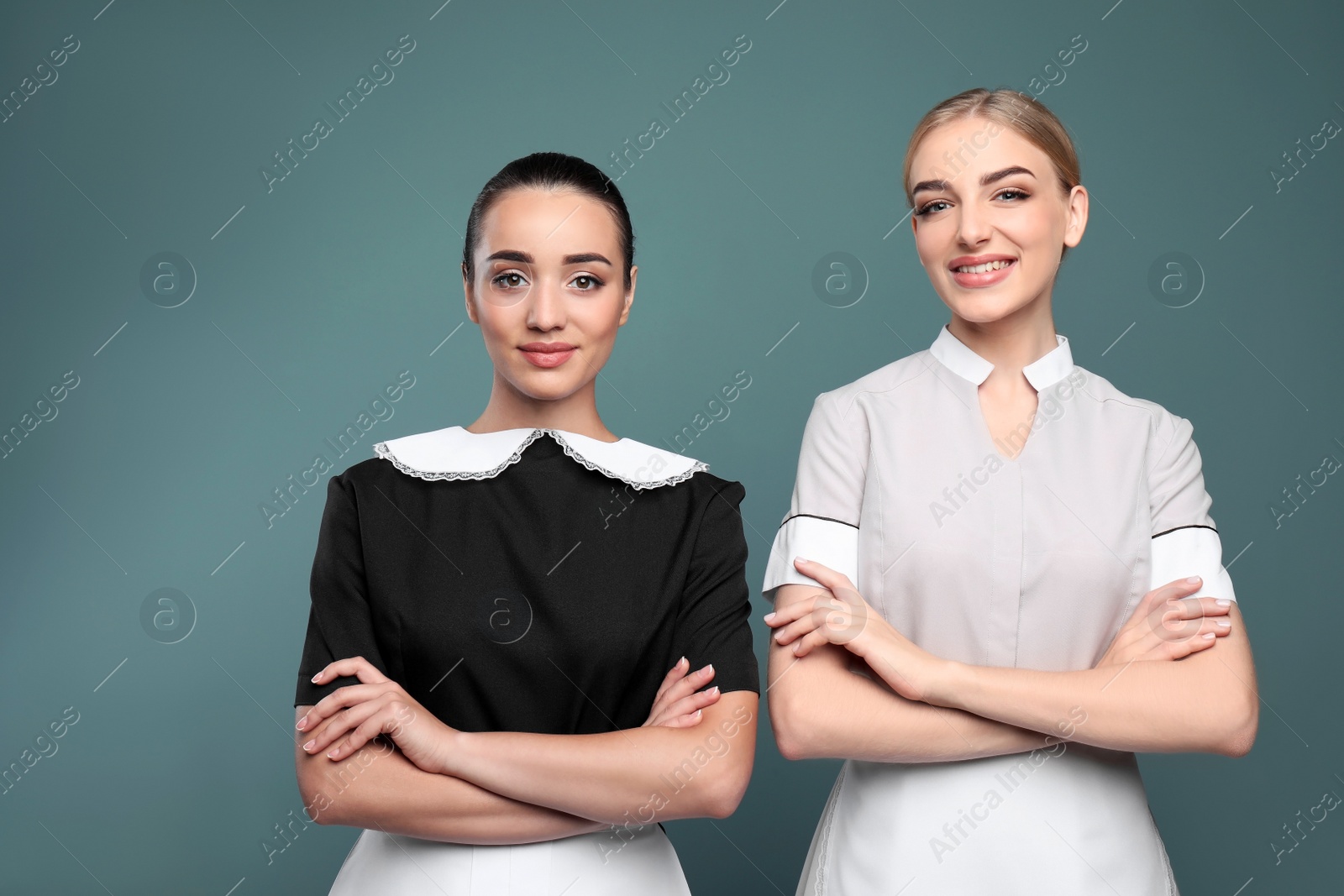 Photo of Portrait of young chambermaids on color background