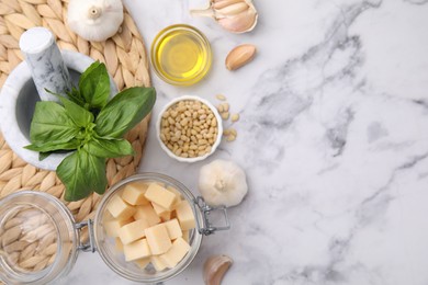 Photo of Different ingredients for cooking tasty pesto sauce on white marble table, flat lay. Space for text