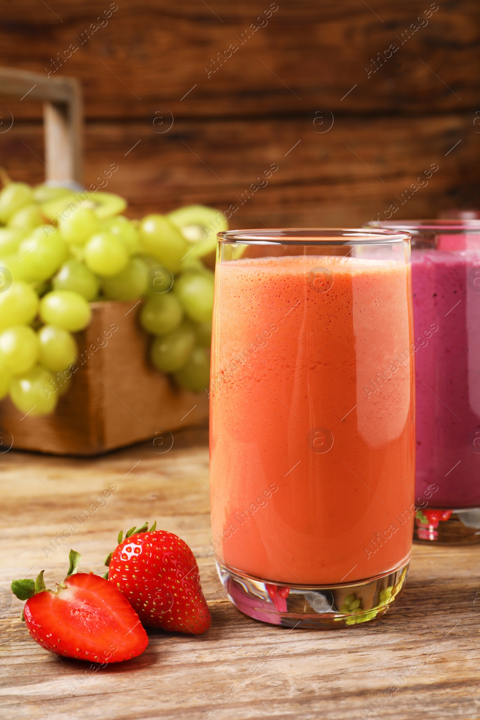 Photo of Glasses with tasty smoothies and ingredients on wooden table