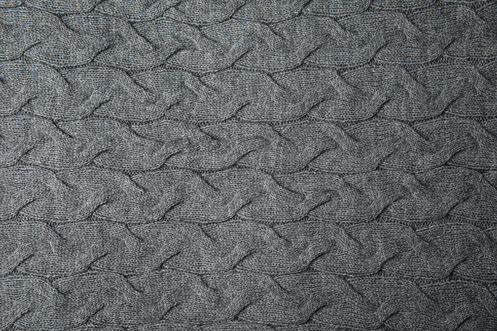 Photo of Soft grey knitted plaid as background, top view