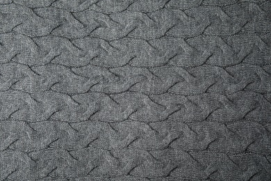 Photo of Soft grey knitted plaid as background, top view