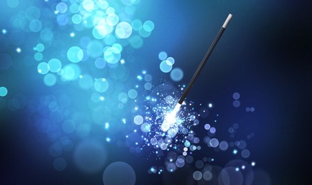 Image of Magic wand and enchanted lights on blue gradient background