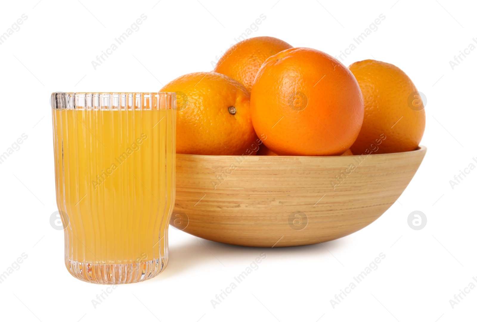 Photo of Fresh oranges in bowl and glass of juice isolated on white