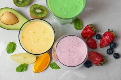 Photo of Flat lay composition with healthy detox smoothies and ingredients on light background