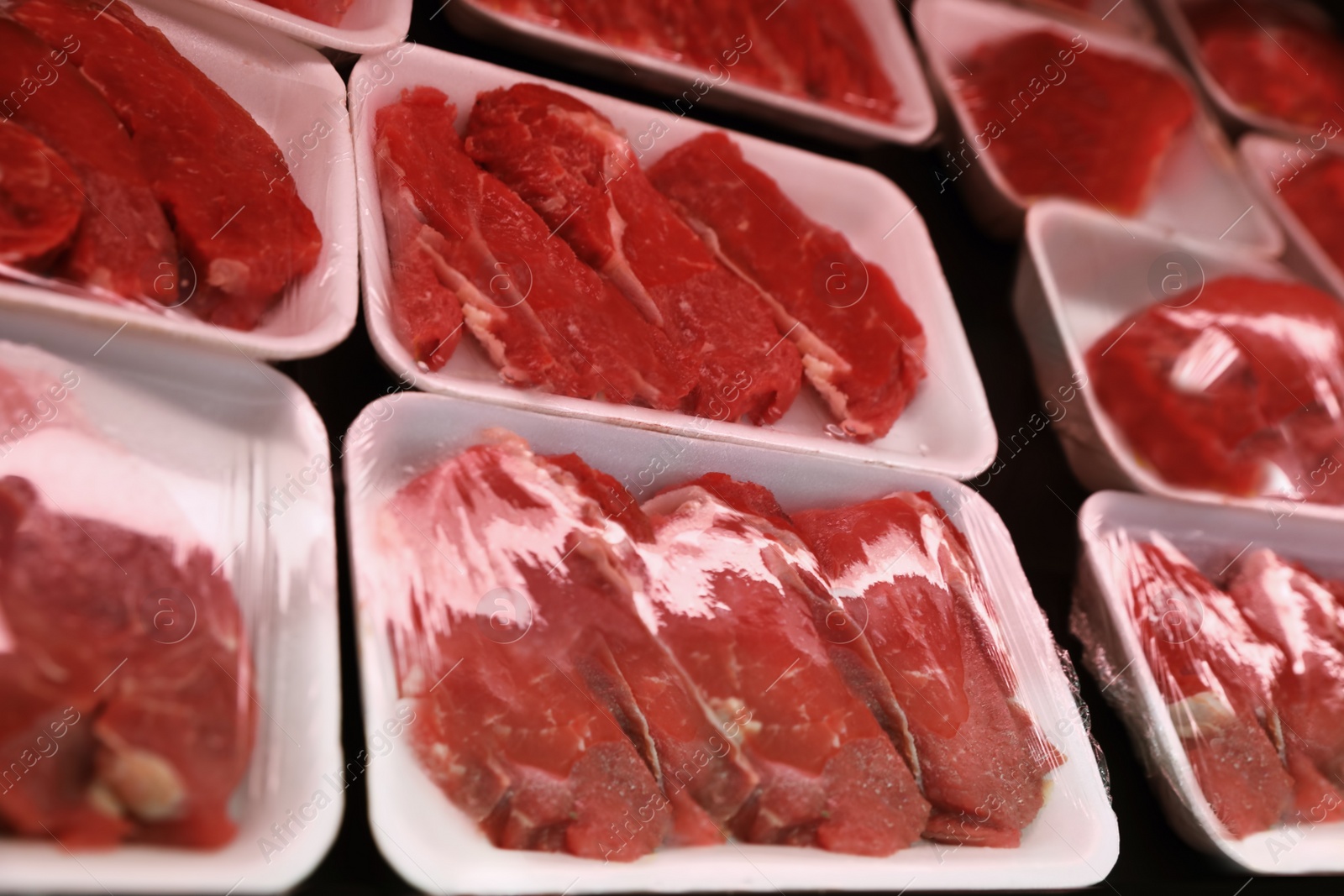 Photo of Shelf with packed beef meat in supermarket