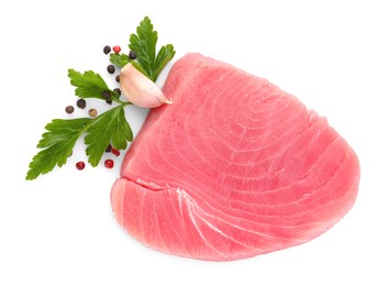 Photo of Raw tuna fillet with spices on white background, top view