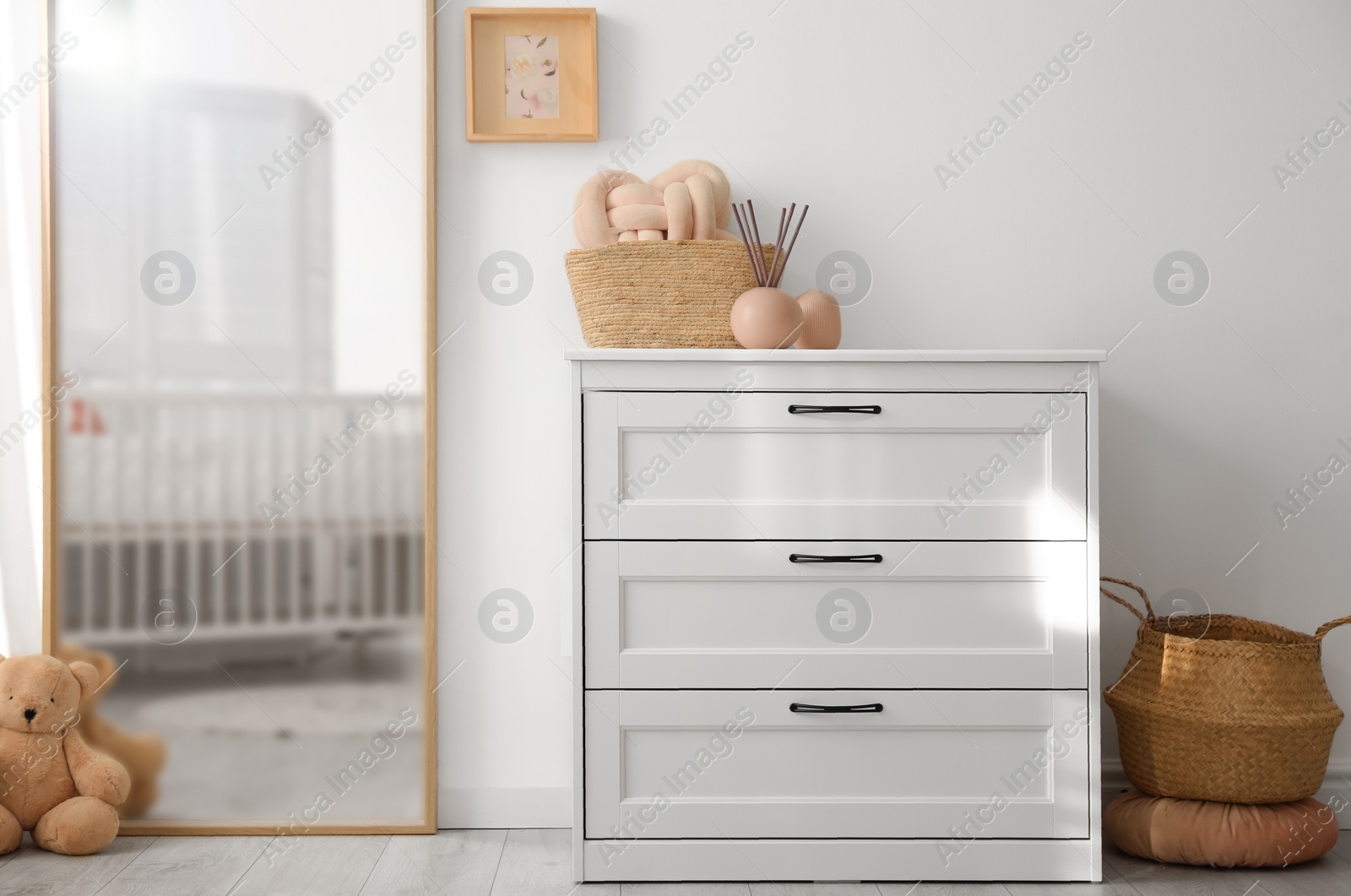 Photo of Beautiful nursery interior with white chest of drawers