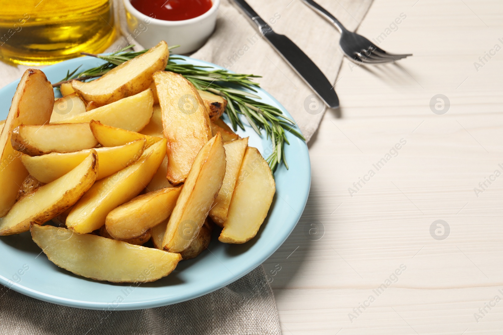 Photo of Delicious baked potatoes served on white wooden table