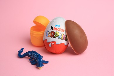 Photo of Sveti Vlas, Bulgaria - July 3, 2023: Kinder Surprise Eggs, open plastic capsule and toy on pink background