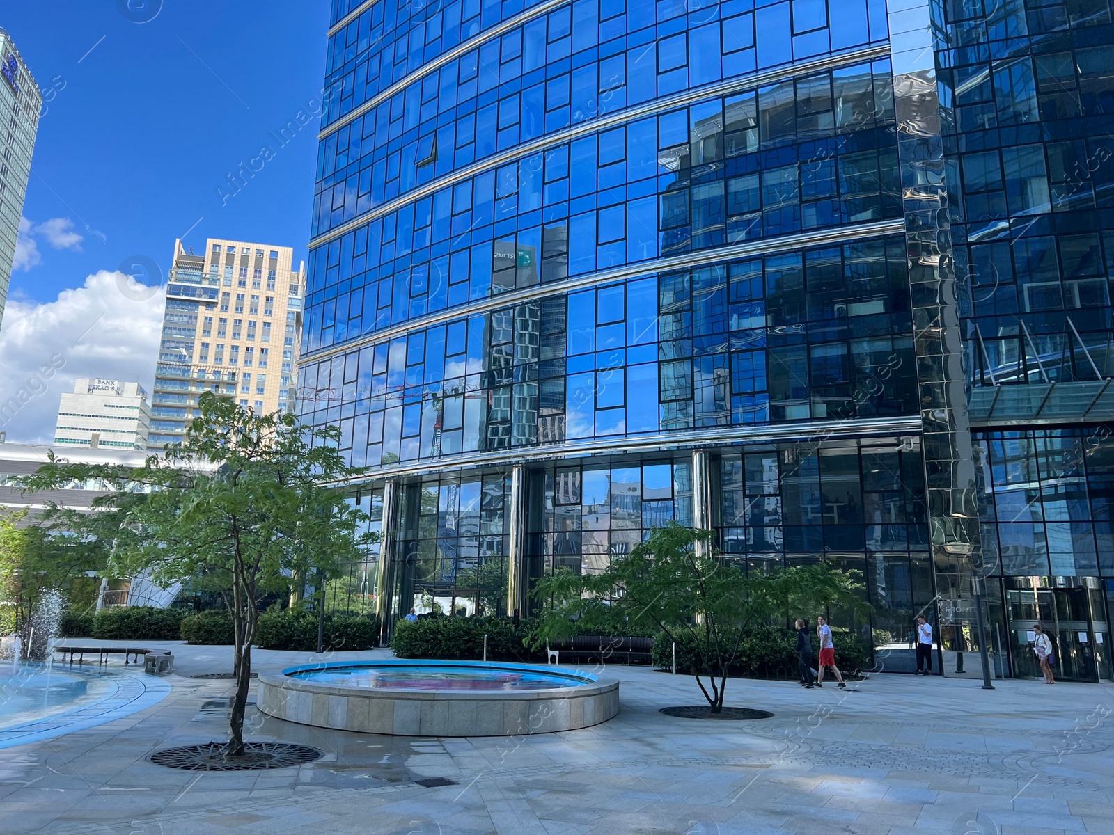 Photo of View of city street with modern buildings on sunny day