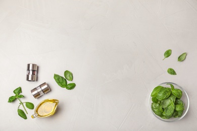 Photo of Flat lay composition with fresh basil leaves  on light background. Space for text