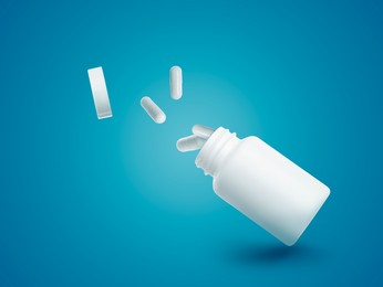 Image of Vitamin capsules flying out from bottle on light blue background