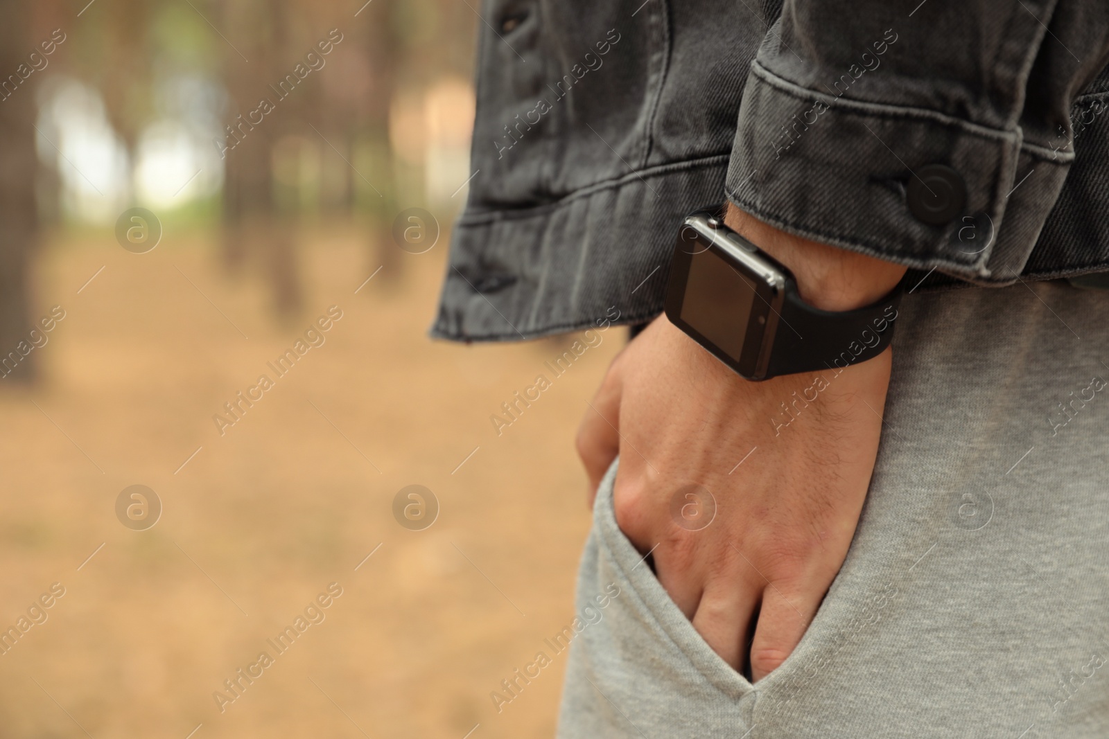 Photo of Man with stylish smart watch outdoors, closeup