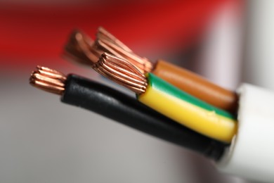 Photo of Colorful electrical wire on blurred background, closeup