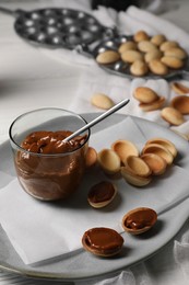 Photo of Delicious walnut shaped cookies with condensed milk on table