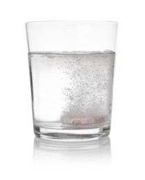 Photo of Effervescent pill dissolving in glass of water isolated on white