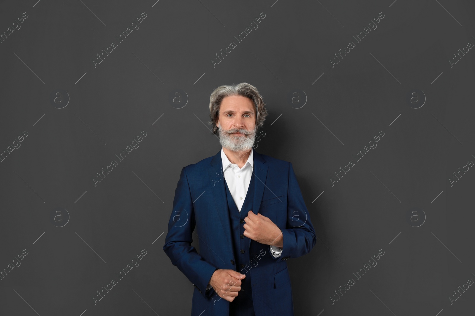 Photo of Portrait of handsome mature man on dark background