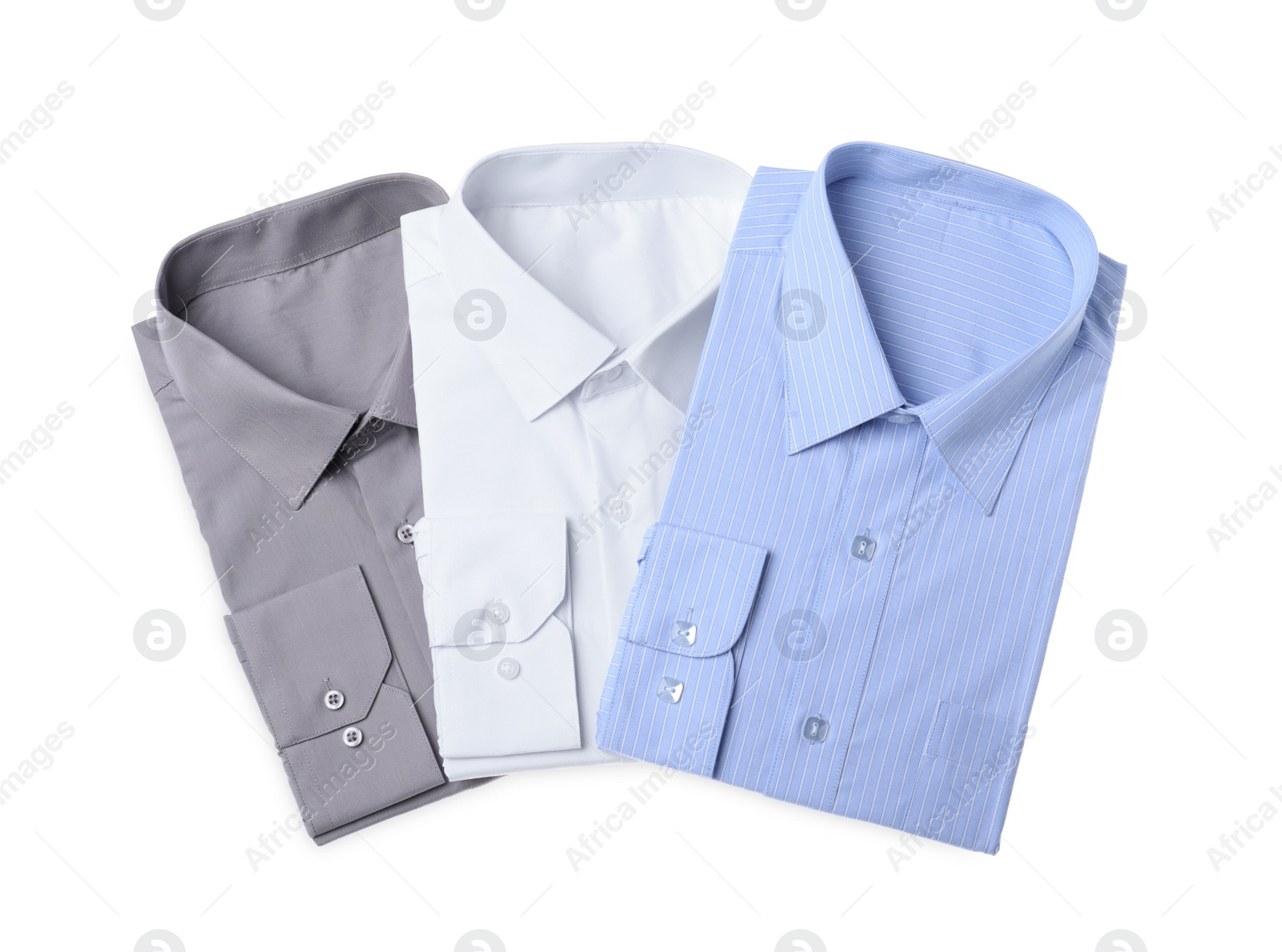 Photo of Stylish shirts isolated on white, top view. Dry-cleaning service