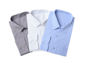 Photo of Stylish shirts isolated on white, top view. Dry-cleaning service