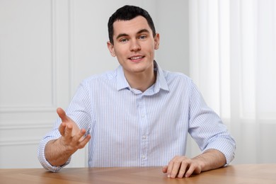 Man having video chat indoors, view from web camera