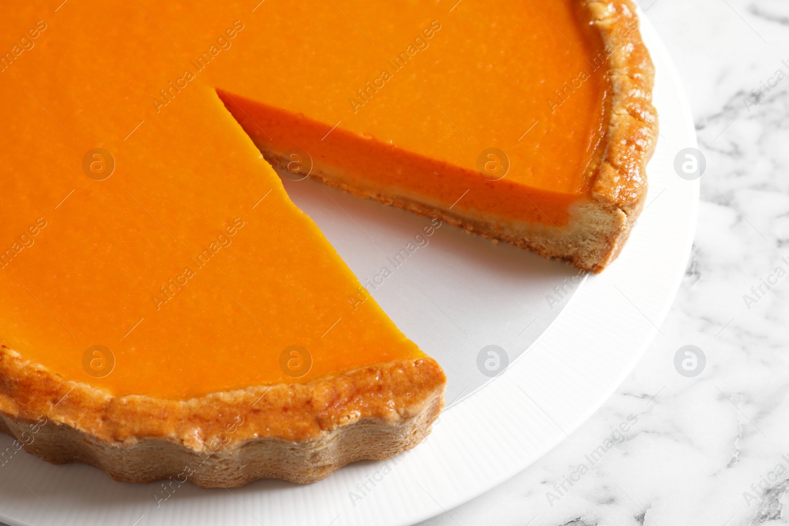 Photo of Plate with fresh delicious homemade pumpkin pie on marble table