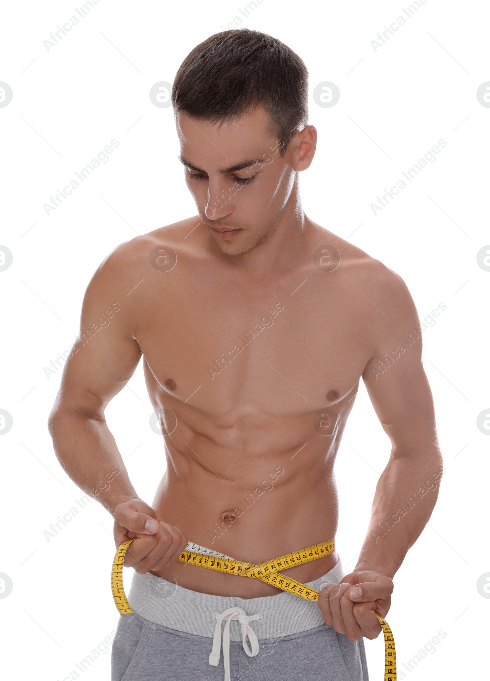 Photo of Handsome shirtless man with slim body and measuring tape around his waist isolated on white
