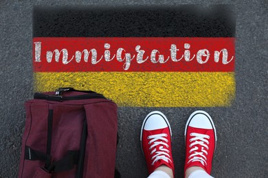 Image of Immigration. Woman with bag standing on asphalt near flag of Germany, top view