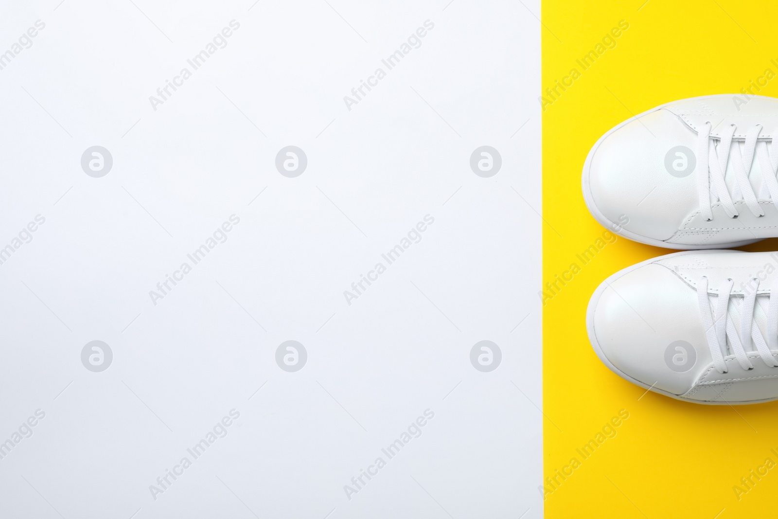 Photo of Pair of sneakers on color background, flat lay. Space for text