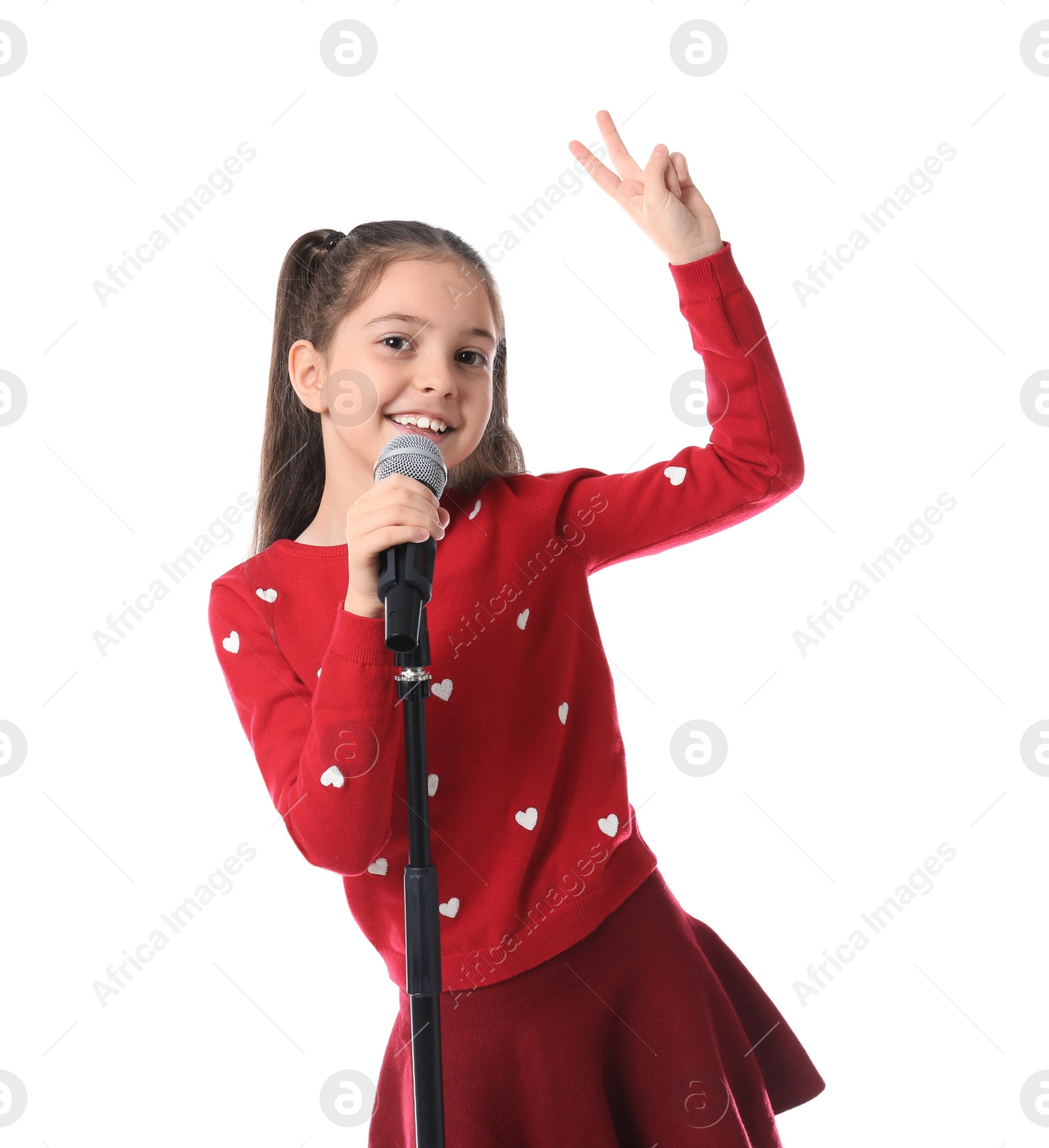 Photo of Little girl singing into microphone on white background