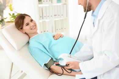 Photo of Gynecology consultation. Pregnant woman with her doctor in clinic