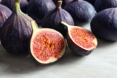 Photo of Bunch of fresh ripe figs on light background. Tropical fruit