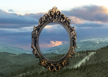 Wooden frame and beautiful mountains under cloudy sky