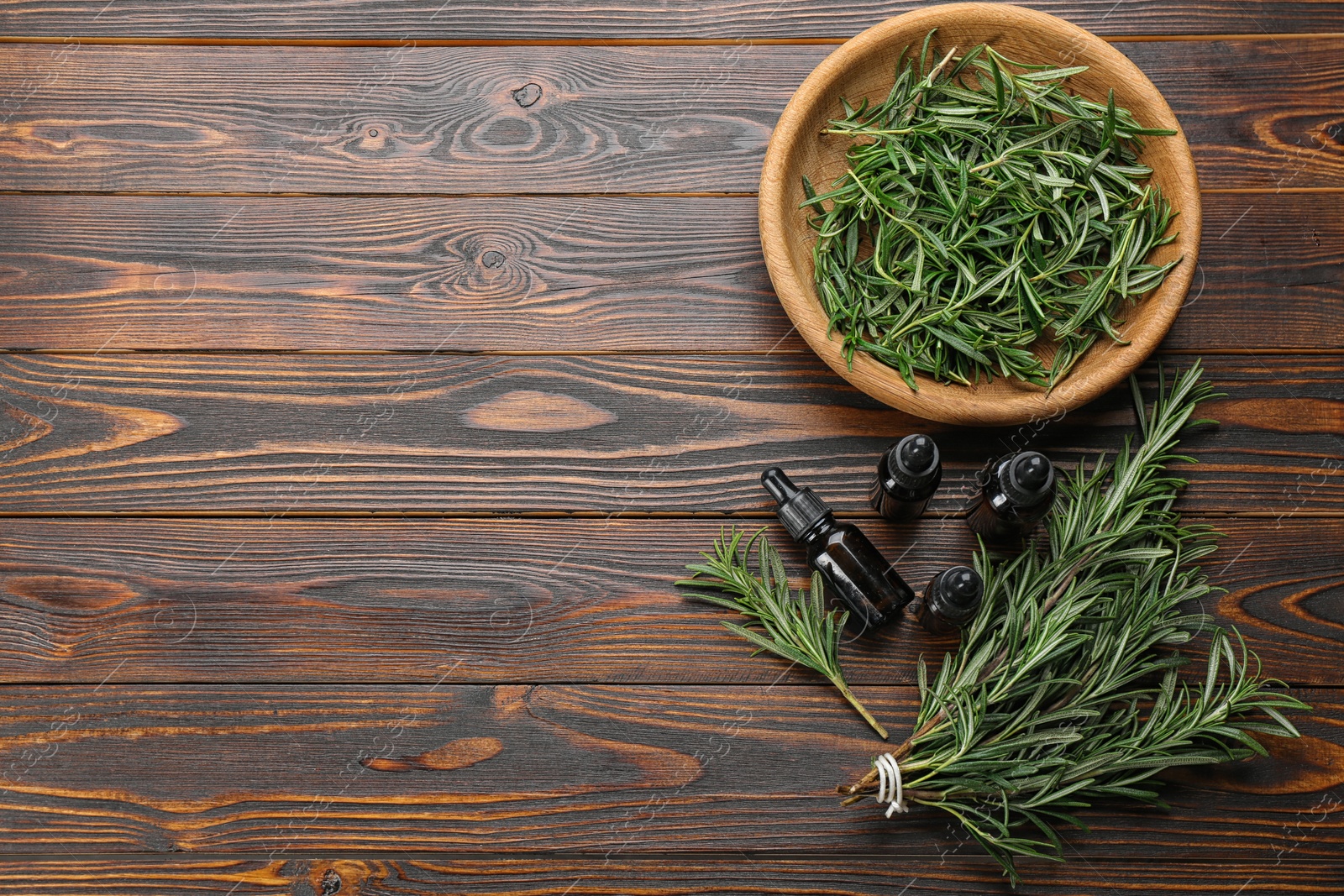 Photo of Flat lay composition with fresh rosemary on wooden table. Space for text