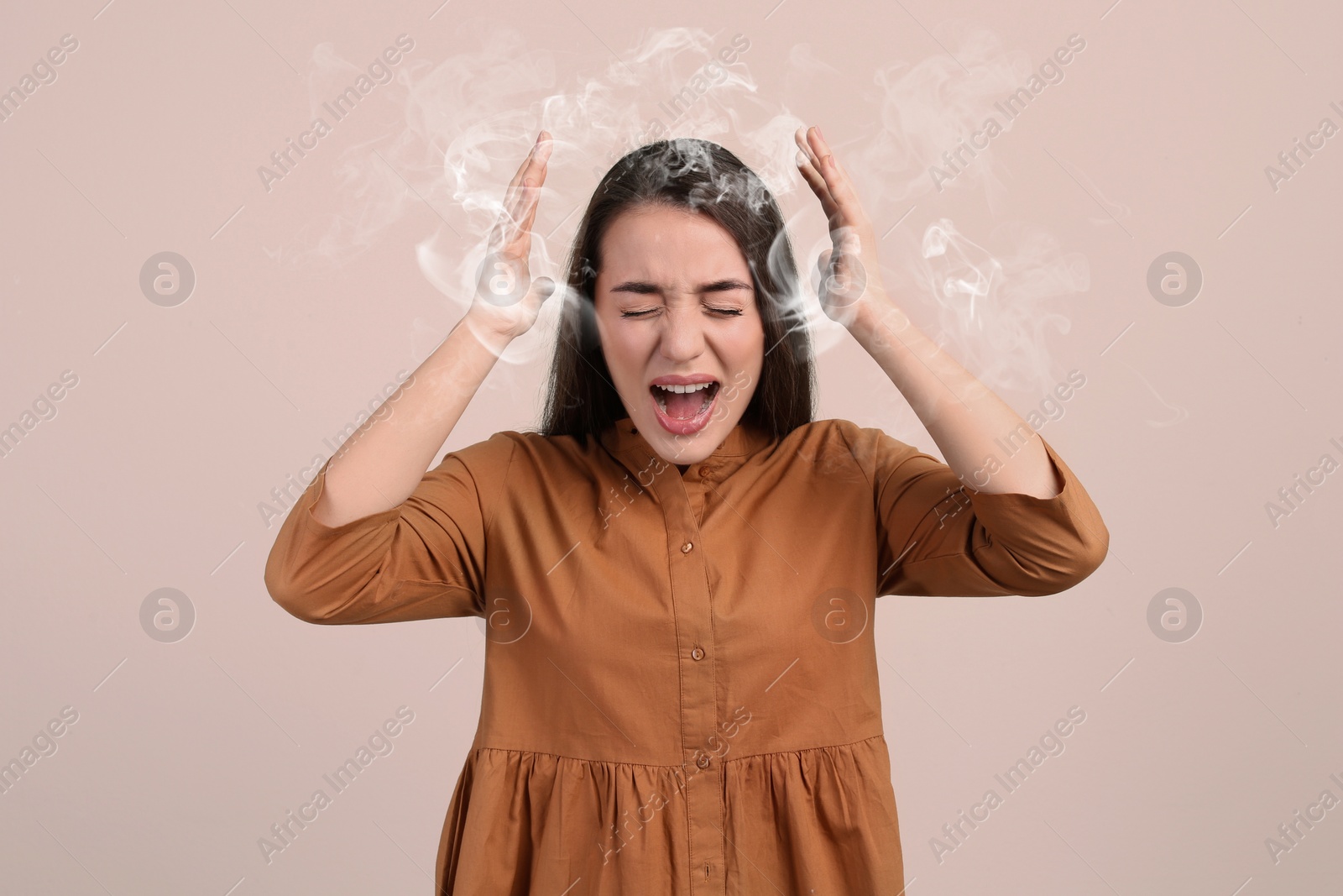 Image of Stressed and upset young woman on light background