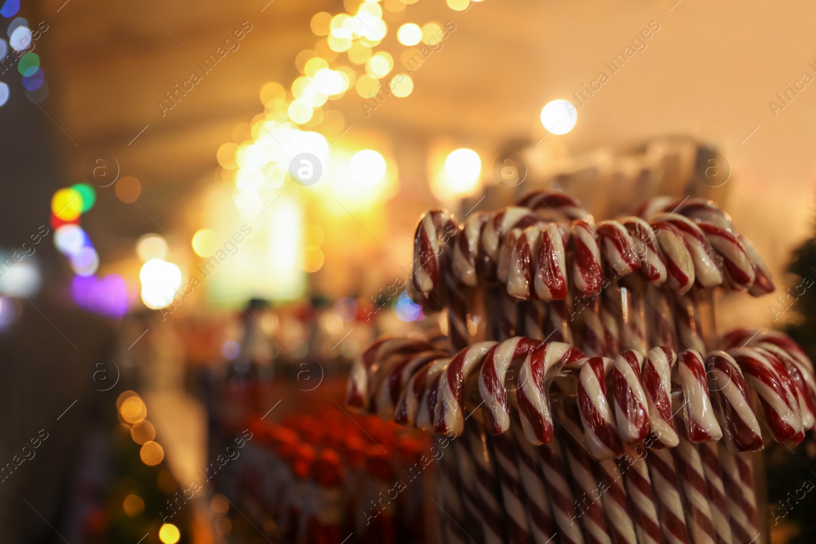 Photo of Candy canes on Christmas fair stall display, closeup. Space for text