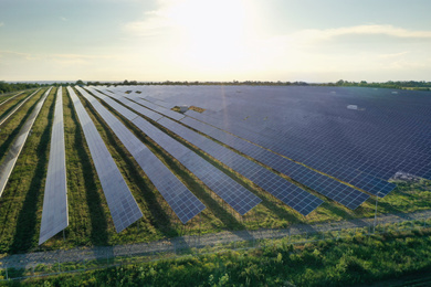 Photo of Solar panels installed outdoors, aerial view. Alternative energy source