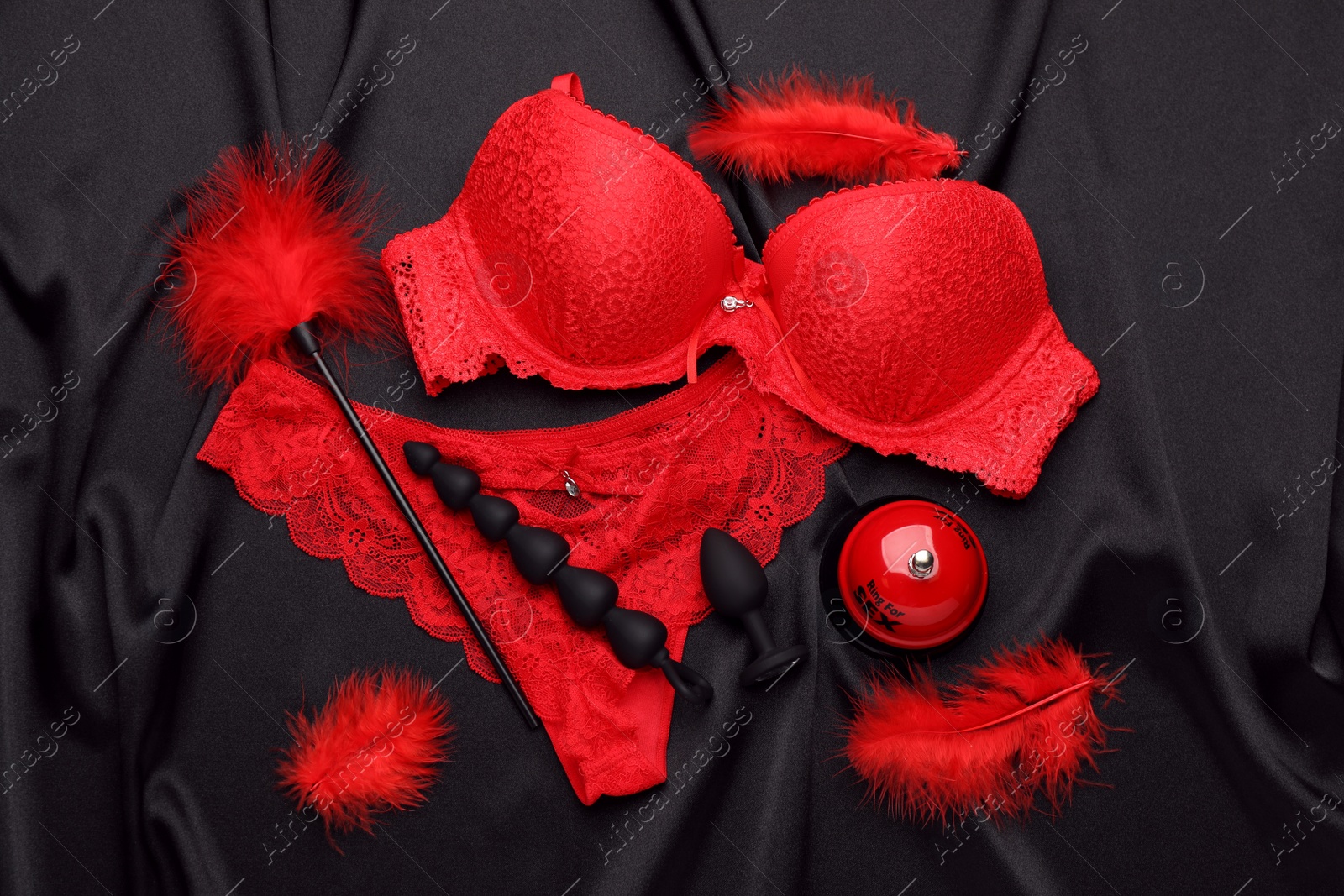 Photo of Sex toys, accessories and lingerie on black fabric, flat lay