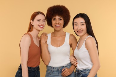 Photo of Portrait of beautiful young women on beige background